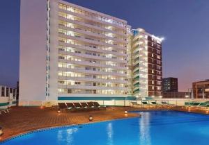 a large building with a swimming pool in front of a building at 10 South Ocean Views in Durban