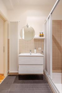 a bathroom with a white sink and a mirror at Rose & Stelle - Favoloso appartamento in centro in Modena