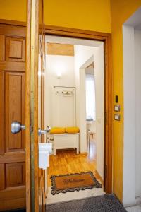 a door leading to a room with a bed at Rose & Stelle - Favoloso appartamento in centro in Modena