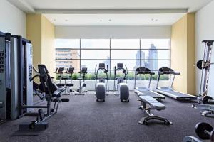 a gym with a row of treadmills and machines at Twilight25 Condo in Cebu City