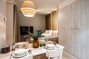 a dining room with a table and chairs and a bed at Arctic Honey City Suite in Rovaniemi