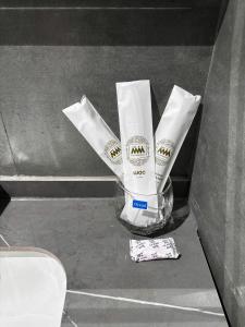 a container ofodorizers sitting on a counter next to a toilet at Wabi Homes in Buon Ma Thuot