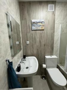 a bathroom with a white sink and a toilet at SOLMAR Playa Gandia SOLO FAMILIAS in Playa de Gandia +31 photos