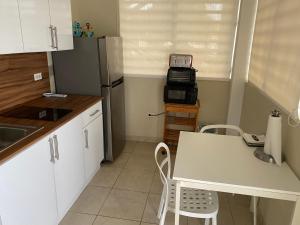 une cuisine avec une table blanche et un réfrigérateur dans l'établissement Apartamento karma, à Culebra