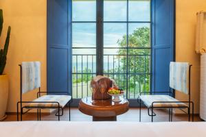 a room with two chairs and a table and a window at Hidden Dalla Gioconda in Gabicce Mare