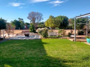 a park with a bench in the grass at Avonlea Cottages in York