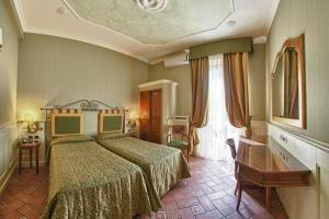 Postel nebo postele na pokoji v ubytování Hotel Pedrini + 37 fotografií