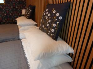 a stack of pillows sitting on top of a bed at Wee Ness Cottage in Inverness