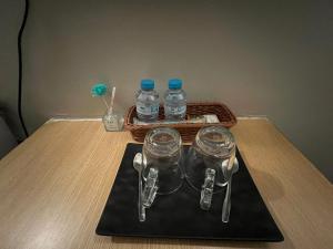 a table with bottles of water and a basket with spoons at Vientiane Star Hotel B in Vientiane +34 photos