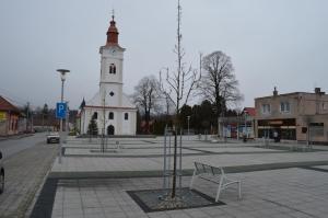 a building with a clock tower with a bench in front of it at Apartment Sučany in Sučany
