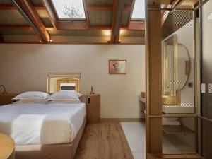 Postel nebo postele na pokoji v ubytování Domus Blanc Boutique Hotel
