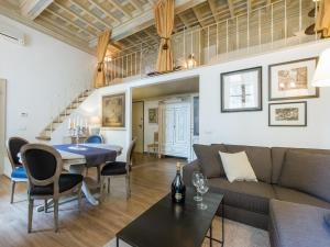 a living room with a couch and a table at Apartments Florence - Orsanmichele view in Florence