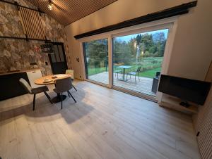 a living room with a table and a large window at Francorchamps studio 8 in Stavelot