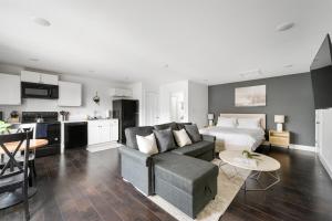 a living room with a couch and a kitchen at The Linden Home in Indianapolis