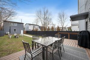 a patio with a table and chairs on a deck at The Linden Home in Indianapolis