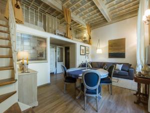 a dining room and living room with a table and chairs at Apartments Florence - Orsanmichele view in Florence