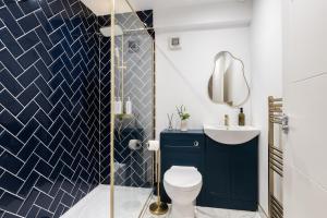 a bathroom with a toilet and a sink at River Side Apartment, City Centre - Beautiful View and Free Parking! in Belfast +10 photos