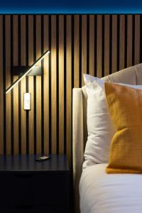 a bedroom with a bed and a table with a pillow at River Side Apartment, City Centre - Beautiful View and Free Parking! in Belfast