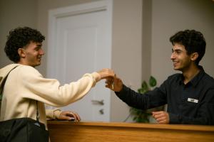 a man shaking another mans hand over a counter at RestArt Boutique Hotel in Dilijan