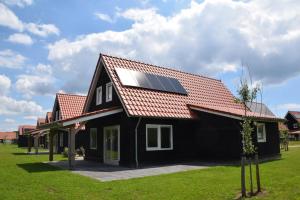 a house with a solar panel on its roof at Vakantiepark Wulpdal in Scherpenisse