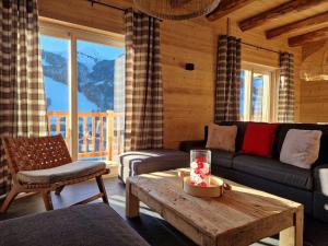 a living room with a couch and a table at Chalet 4 chambres, confort moderne, Arêches-Beaufort - FR-1-342-331 in Beaufort
