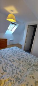 a bedroom with a large bed with a yellow ceiling at Green Acres Bretagne in Maël-Carhaix