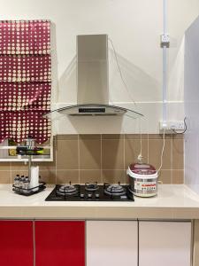 a kitchen with a stove top oven in a kitchen at La Vista Villa Private Pool in Kampong Gong Badak