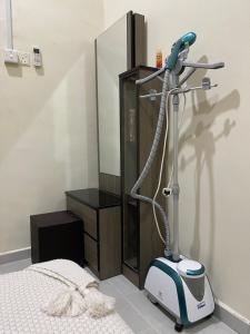 a room with a hair dryer next to a bed at La Vista Villa Private Pool in Kampong Gong Badak