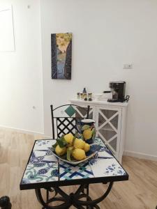 a table with a plate of fruit on it at B&B DieMme Amalfi Coast in Vietri sul Mare
