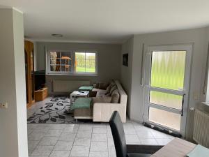 a living room with a couch and a table at Eifel Holiday in Prüm