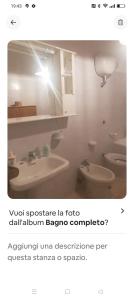 a picture of a bathroom with two toilets and a sink at Casa David in Cava deʼ Tirreni