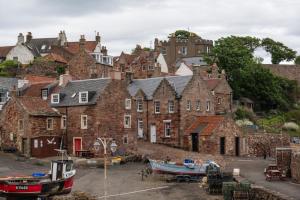 a group of buildings with boats in front of them at Turret House in Crail