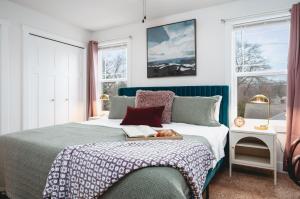 a bedroom with a bed with a book on it at NEW Ivy House 3BR Townhome Downtown Beaches Wineries in Traverse City