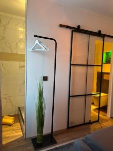 a sliding glass door with a hanger and a plant at Ada&Cris Apartament in Klotten
