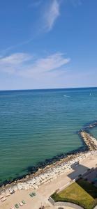 an aerial view of the beach and the ocean at LAMAR SUITES Seafront Apartments in Misano Adriatico