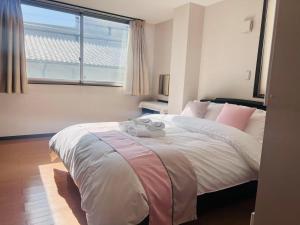 Postel nebo postele na pokoji v ubytování 桜の舞3号馆 Sakura Dance 3