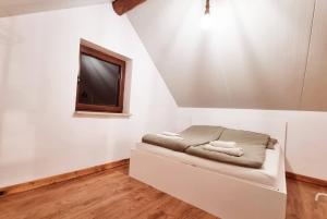a room with a bed with a tv on the wall at Leśna Przystań in Busko-Zdrój