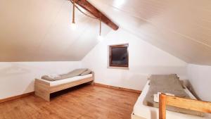 a attic room with a bed and a tv at Leśna Przystań in Busko-Zdrój +16 photos