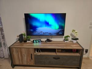 a television on top of a wooden entertainment center at Maria Apartment 2 in Wolfsburg