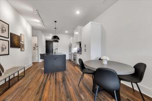 a kitchen and dining room with a table and chairs at 204- City loft w parking & BBQ in Atlanta