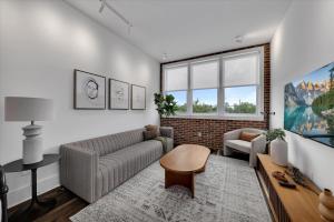 a living room with a couch and a table at 204- City loft w parking & BBQ in Atlanta