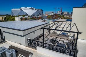 a balcony with a table and chairs on a roof at 204- City loft w parking & BBQ in Atlanta