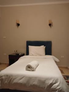 Ένα ή περισσότερα κρεβάτια σε δωμάτιο στο Pyramids Way Inn