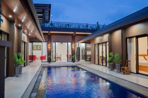 an indoor swimming pool in the middle of a house at MeyGun House in Lovina