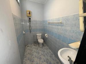 a bathroom with a toilet and a sink at Patong Canal Villa 101 in Patong Beach
