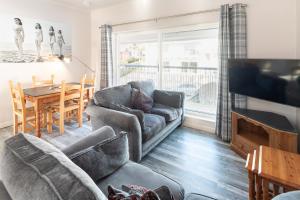 un soggiorno con un divano e un tavolo di Woolacombe Beach Retreat Apartments a Woolacombe