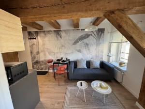 a living room with a blue couch and a table at Apartament Centro 10 in Leszno