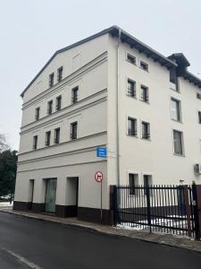 a white building on the side of a street at Apartament Centro 10 in Leszno +27 photos