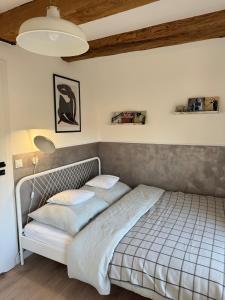 a bed with two pillows on it in a bedroom at Apartament Centro 10 in Leszno