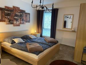 a bedroom with a bed with blue sheets and pillows at Köln Apartment I in Cologne